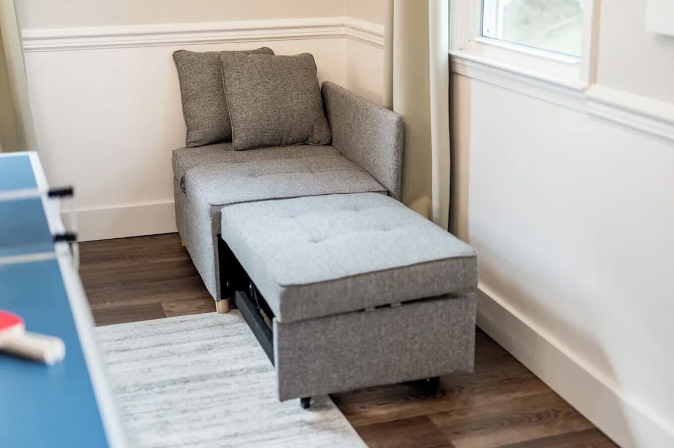 This corner chair converts into a small bed for a child.