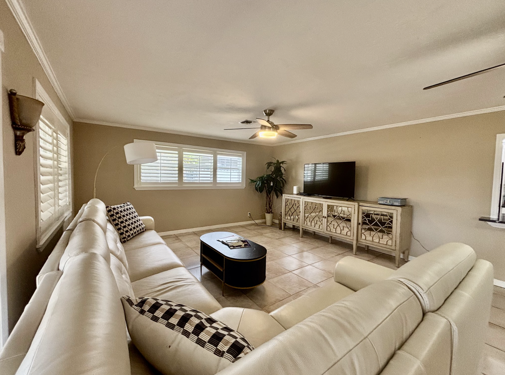 Our expansive rear living room has an abundance of seating and cozy nooks, as well as a comfortable couch with recliners.