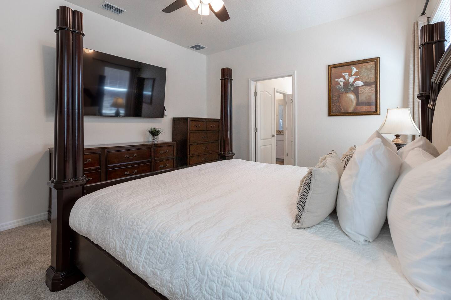 Downstairs Master Bedroom with California King Poster Bed with automatic bed incline and private bathroom and shower. Includes a 70 inch TV.  Luggage rack & laundry basket in closet.
