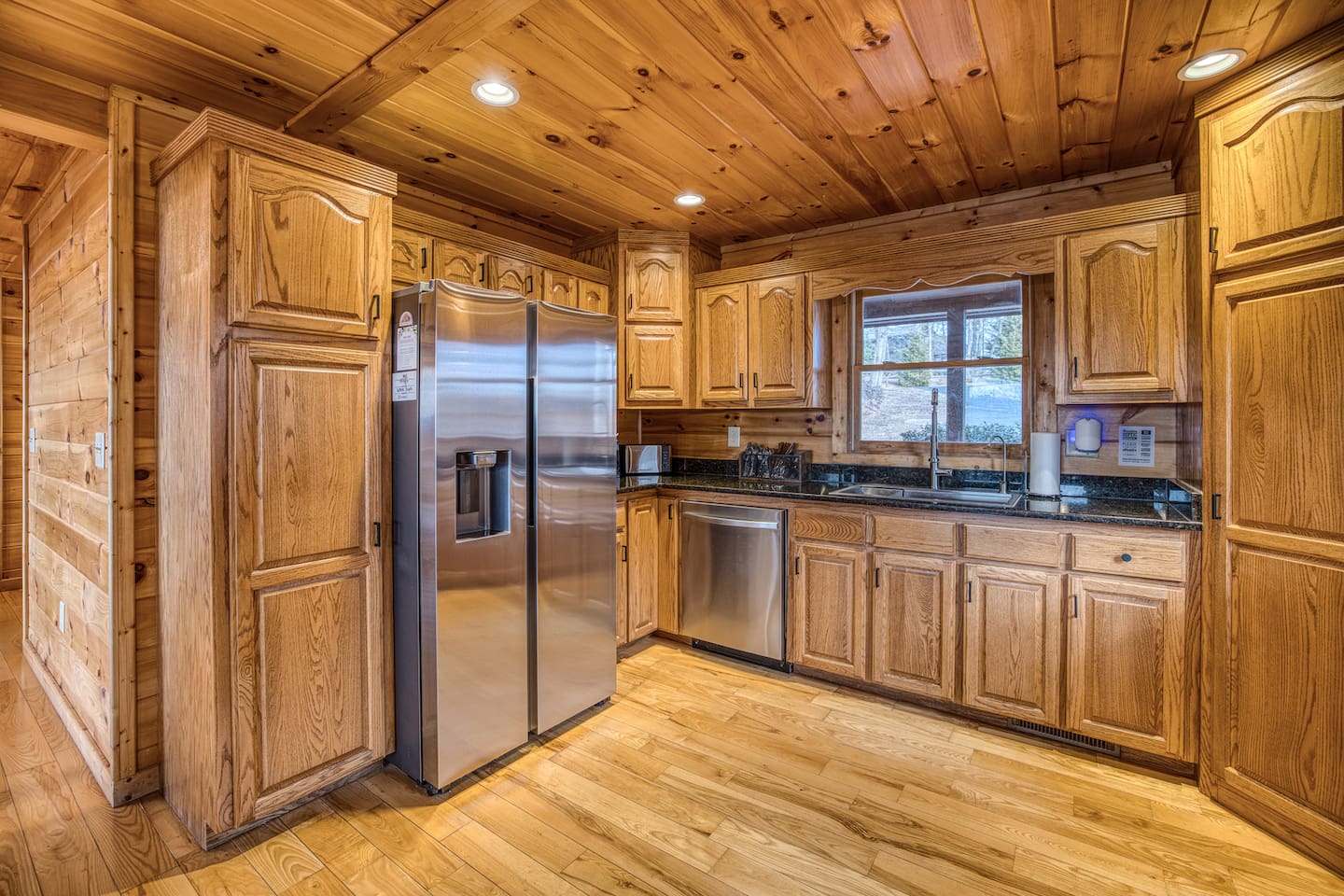 Fully stocked kitchen with low tox features like reverse osmosis water filter under the kitchen sink and attached to the fridge water, stainless steel pots and pans, glass and ceramic bakeware, stainless and silicone cooking utensils, and more!