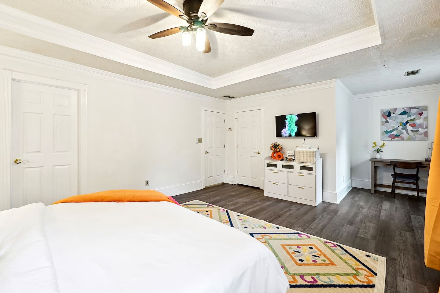 Bedroom 3 is located upstairs, a master bedroom featuring a king bed, TV, a private en-suite bathroom, and a dedicated desk space.