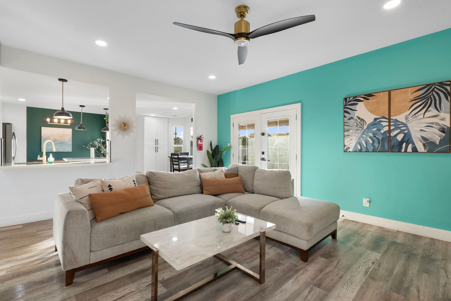 Open living space with vibrant turquoise accent wall.