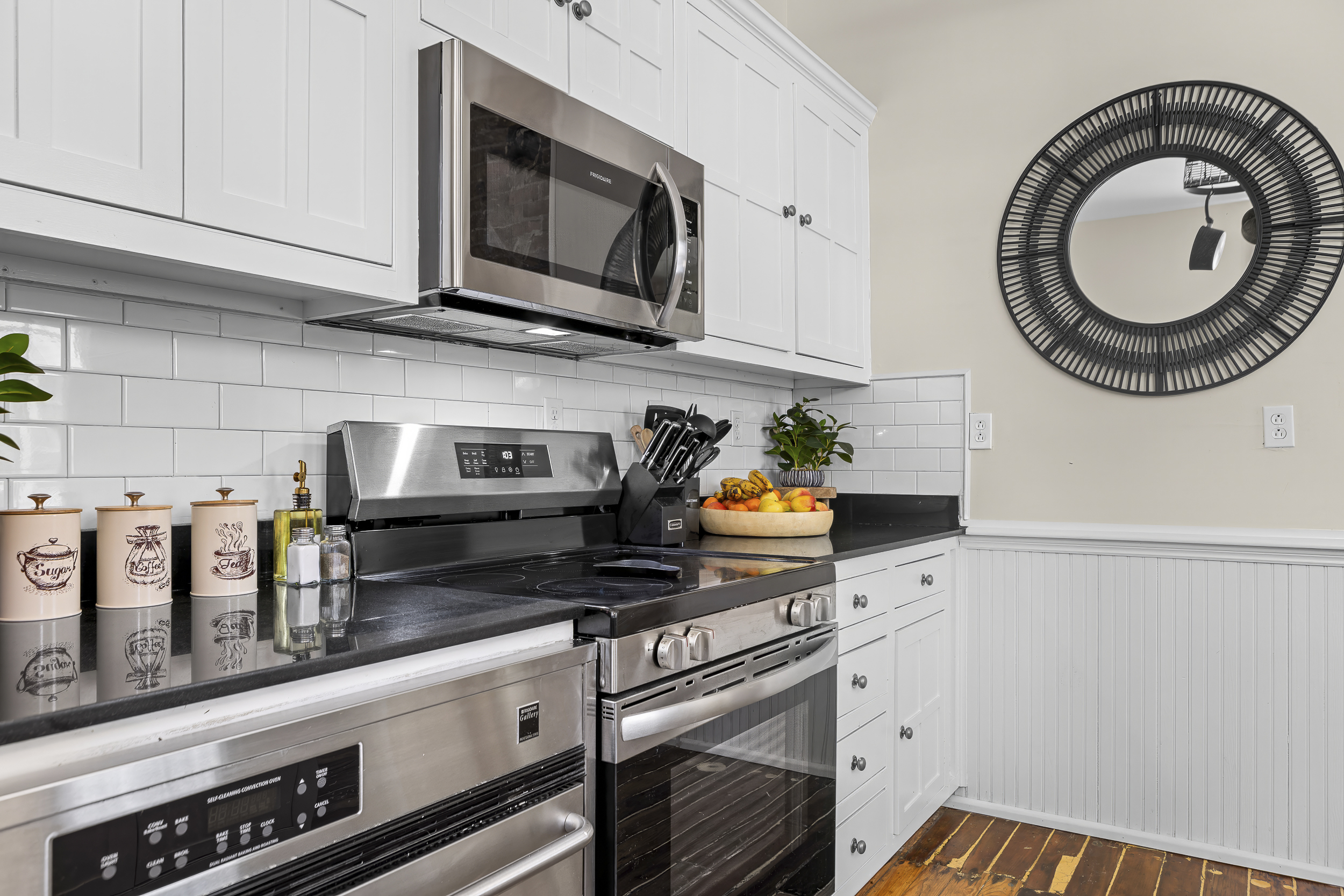 White subway tile, a stainless range, and all the cookware you need for a proper group meal.