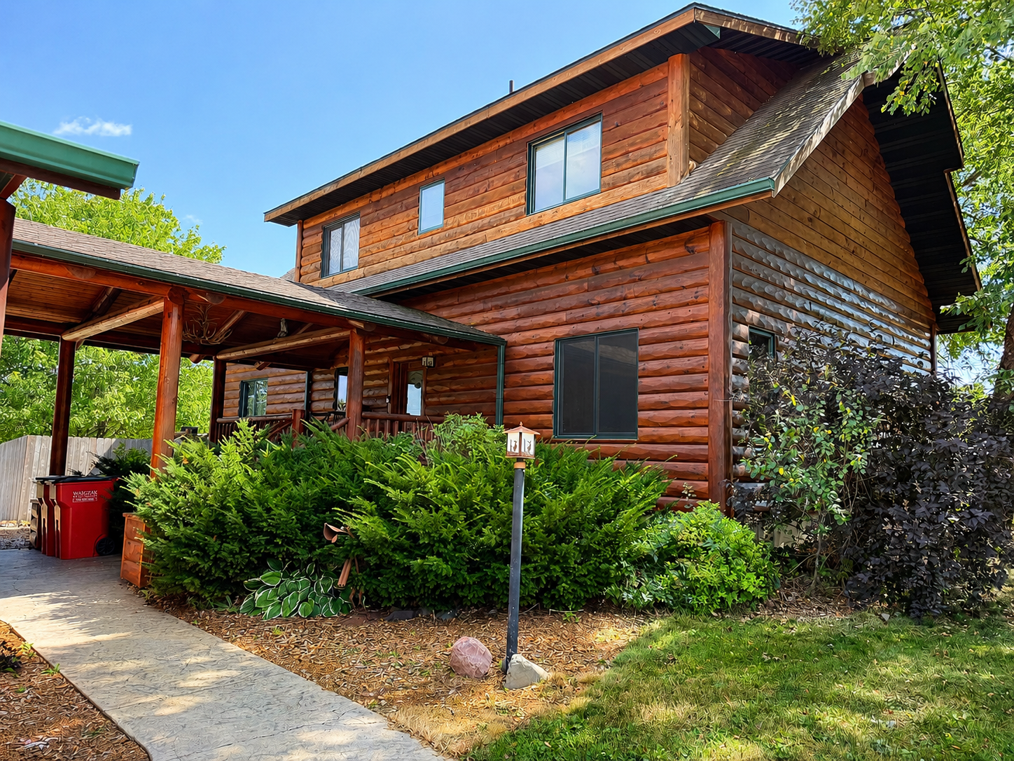 Entrance to the house as you walk up to the covered porch give the feel of a classic Northwoods charm from the moment you arrive.
