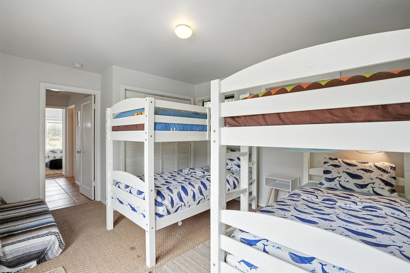 - Bunk room with two sturdy white bunk beds, sleeping up to four guests comfortably  
- Playful ocean themed bedding brings a fun touch for younger visitors  
- Neutral flooring and soft lighting create a cozy retreat for rest and play