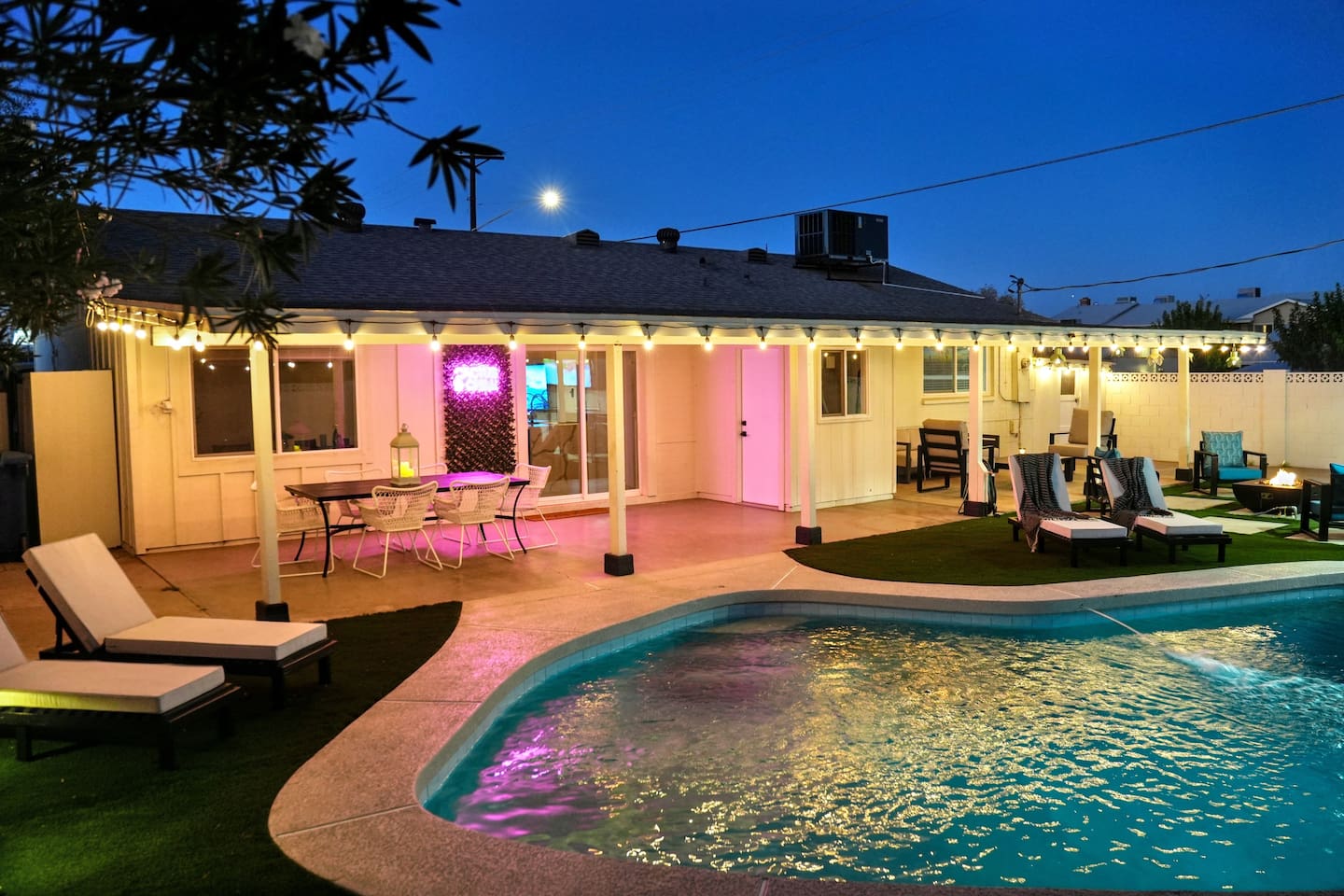 As the sun sets, the backyard comes to life with soft and inviting lights to dine, swim, or play under the Arizona sky.