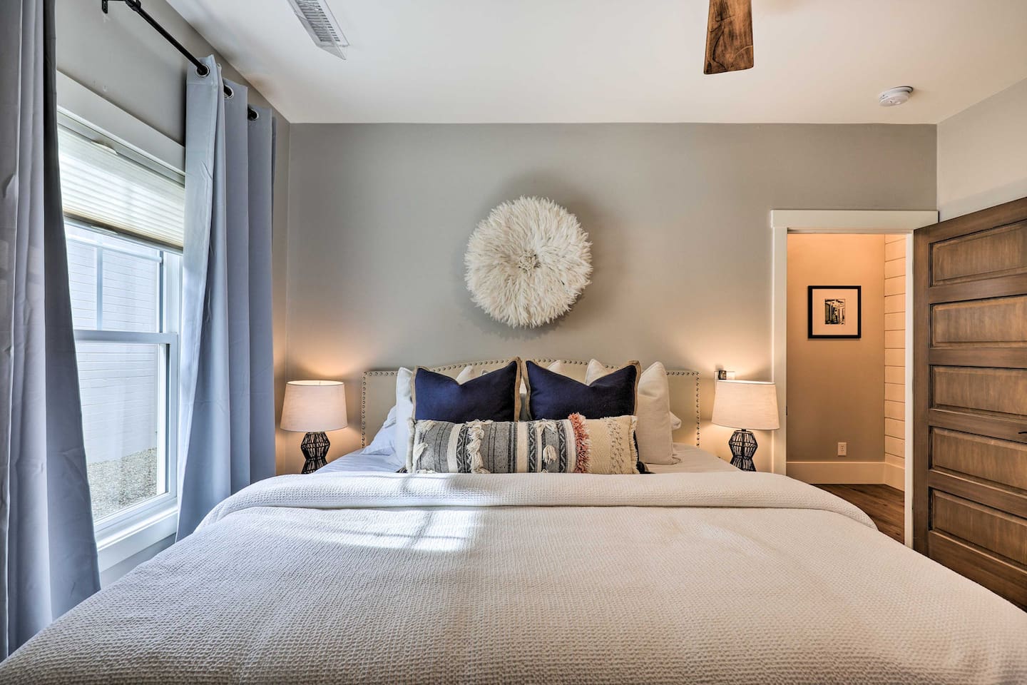 Plush pillows and warm lamplight make this room feel like your own private escape.