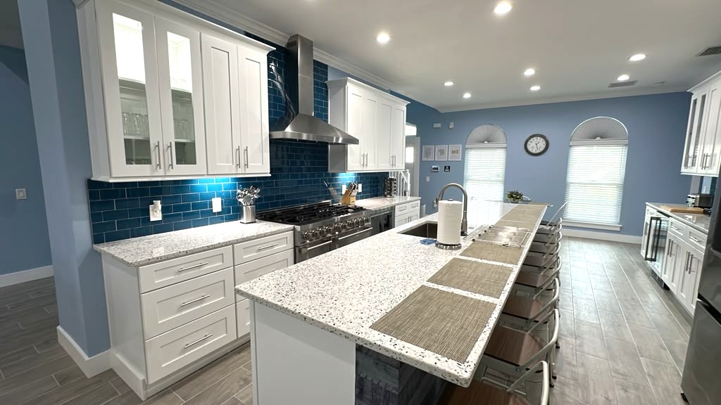 Chef Kitchen with huge island, range, two fridges, drinks fridge, and more. 