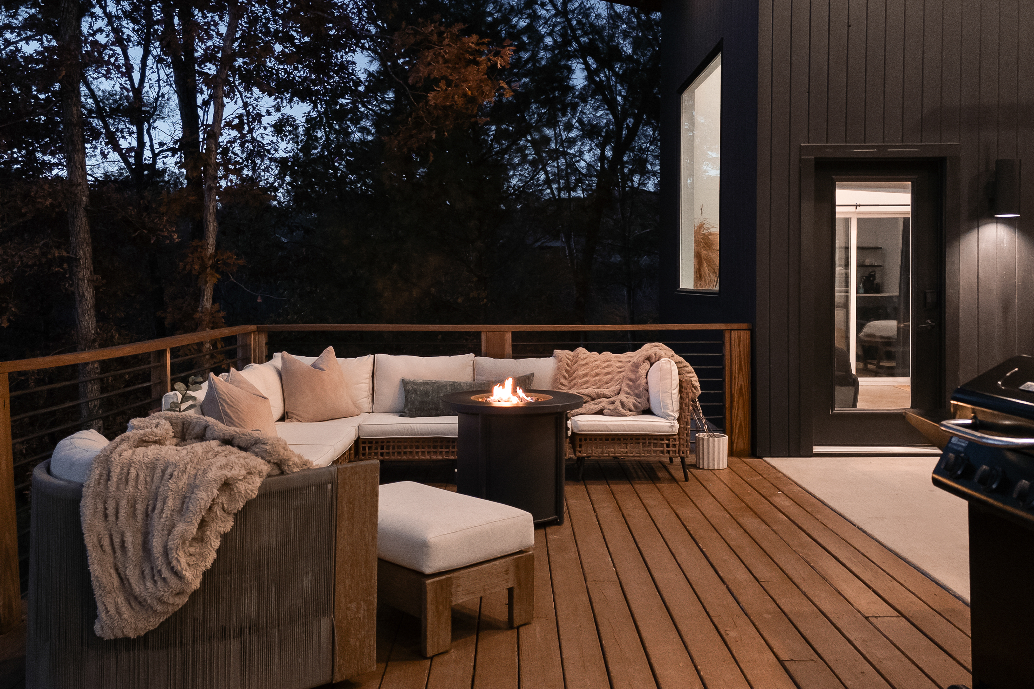 {Outdoor Lounge} Cozy corner seating with a fire pit and soft throws—perfect for evening conversations under the trees.