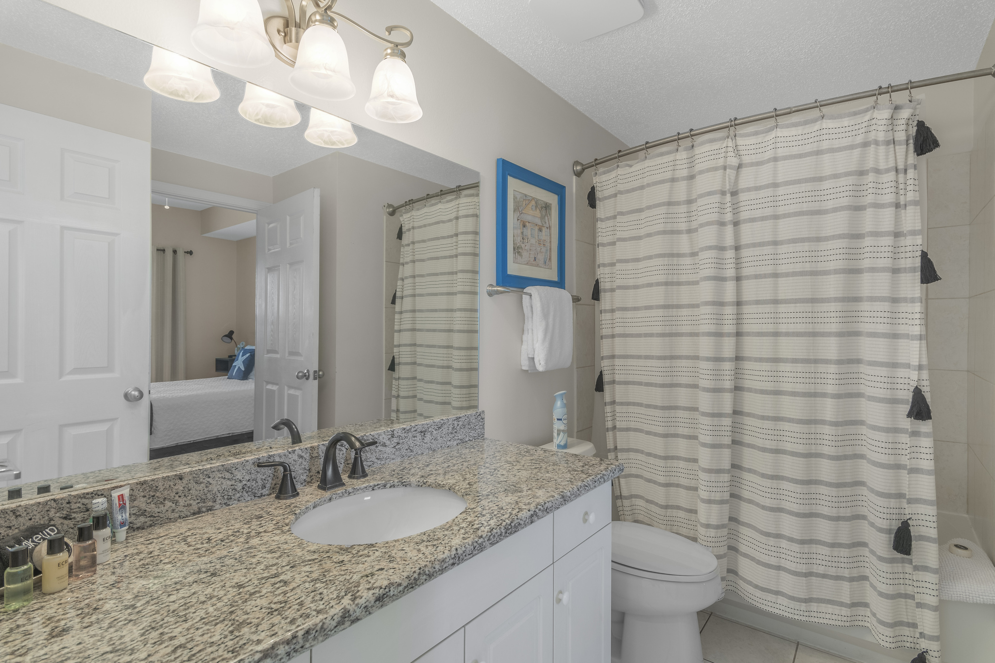 Secondary bathroom has granite countertops and shower/tub combo