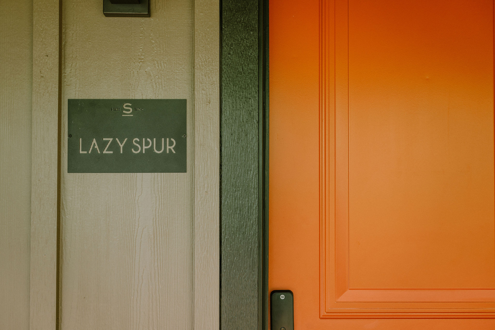 The private entrance to the Lazy Spur Suite at Gaines Ranch on the Square — smart-lock self check-in, no front desk, no waiting.