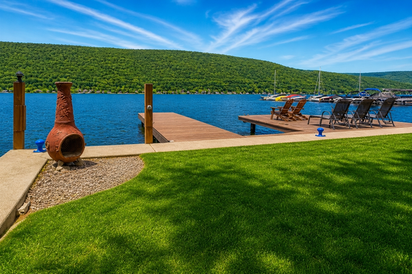 Nestled at the edge of a serene lake, this charming dock features a row of inviting, comfortable chairs, perfect for relaxing and enjoying the peaceful surroundings. The chairs, crafted from weather-resistant materials, are designed for comfort with 