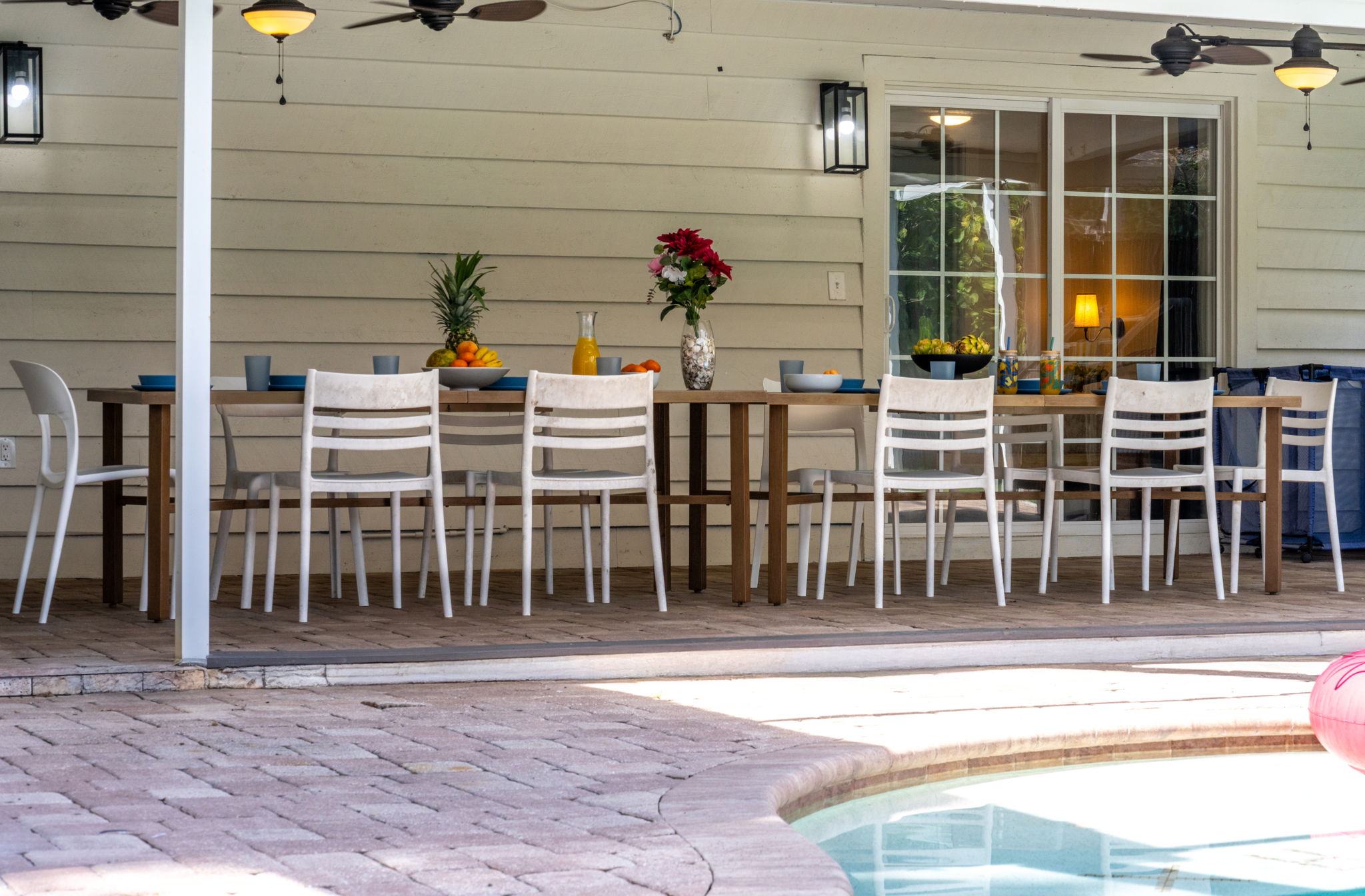 The covered patio opens to a serene pool area, ideal for al fresco dining and entertaining under the Florida sunshine.