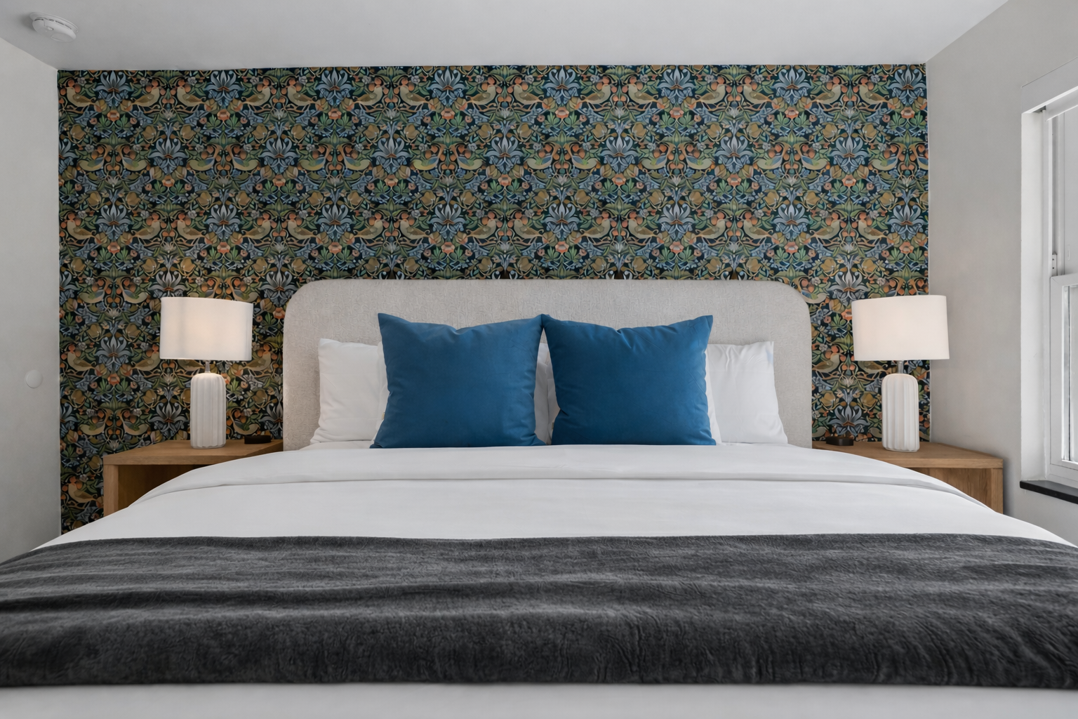 Stylish bedroom retreat with a plush bed, bold accent wall, soft lighting, and hotel-quality comfort for a truly relaxing stay.