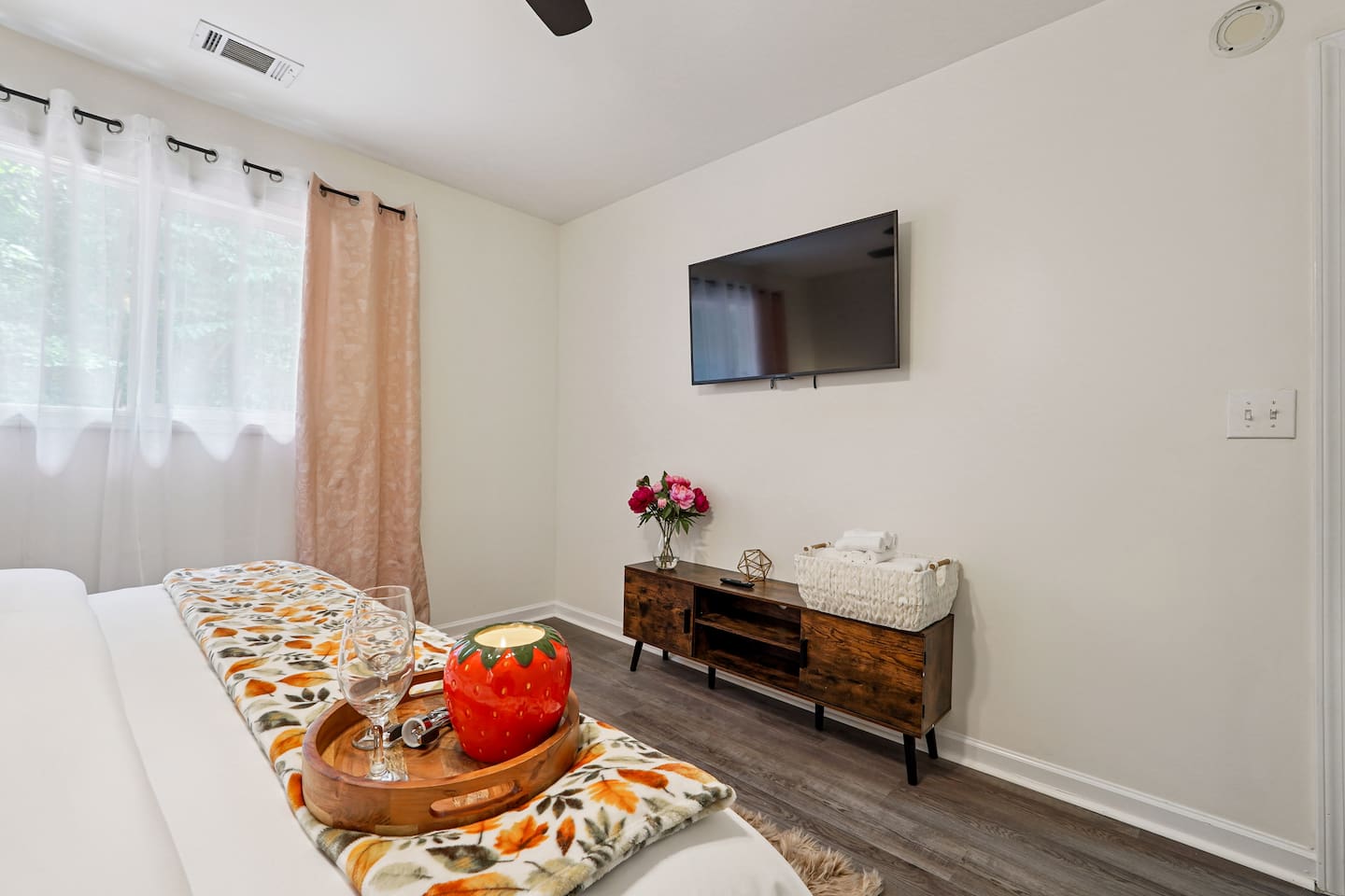 Master bedroom featuring a comfortable king bed and an Amazon Fire-powered Smart TV. The shared bathroom is conveniently right next door. This room includes 2 full-body towels, 2 washcloths, and 2 hand towels for your stay.