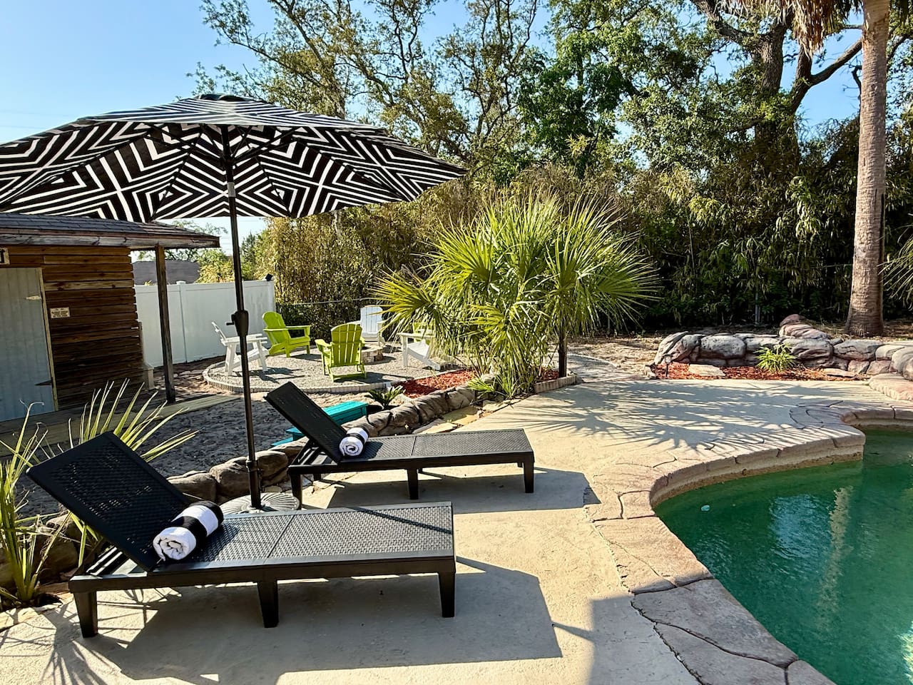 Relax in style in our dreamy backyard oasis. Whether you're soaking up the sun or enjoying a cool breeze, this serene corner is your perfect escape.


