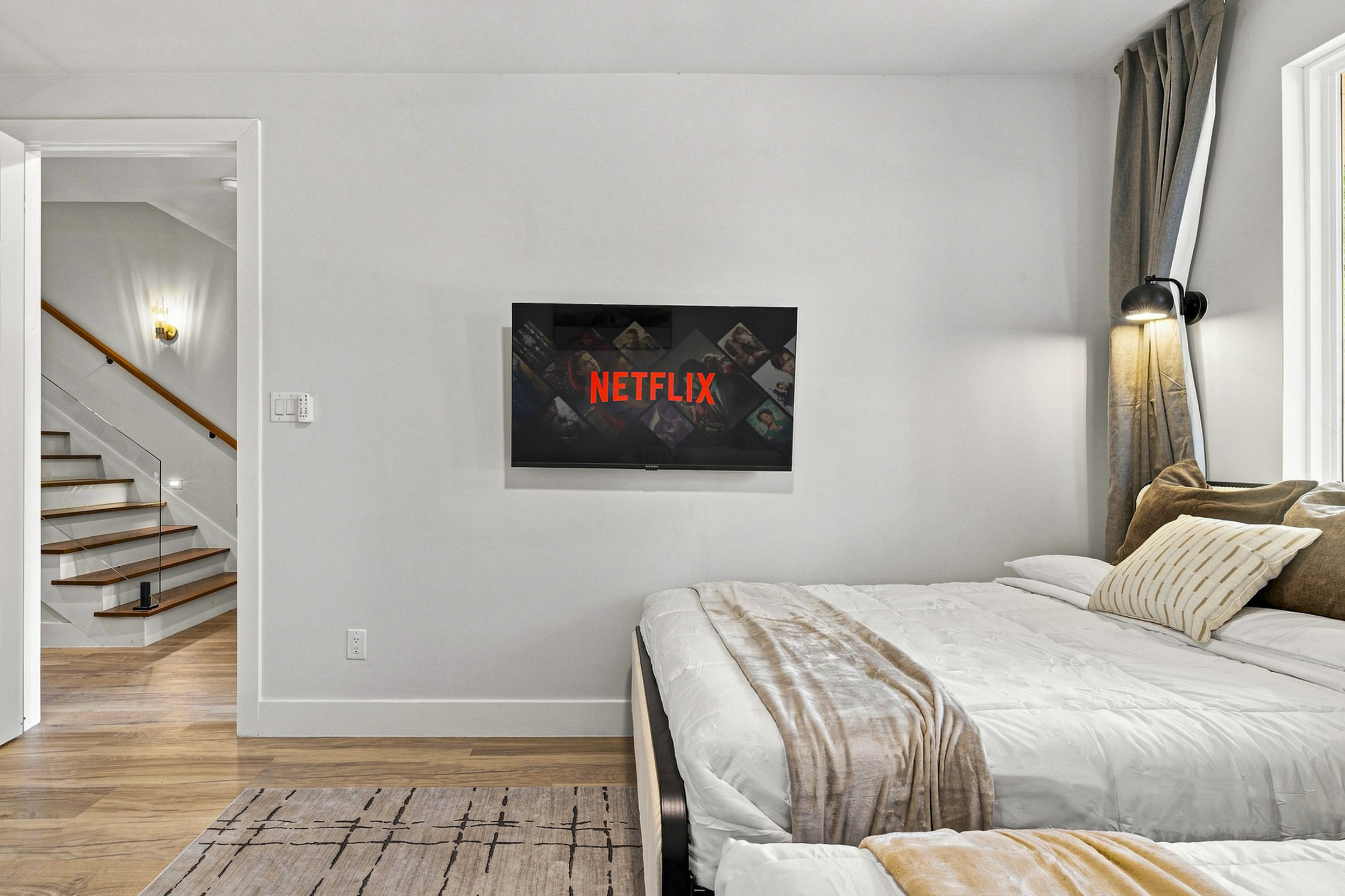 Relax and unwind with a plush bed, smart TV, and stylish decor in this serene retreat!