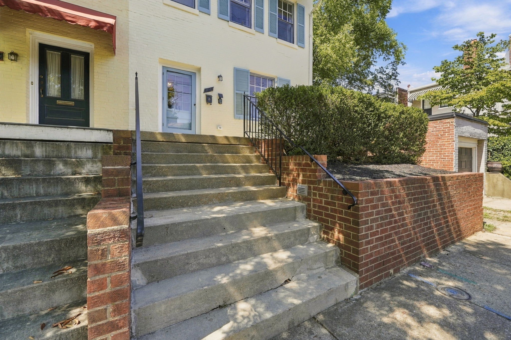 Welcome Entrance: Step into charm with inviting steps, landscaped greenery, and historic vibes!