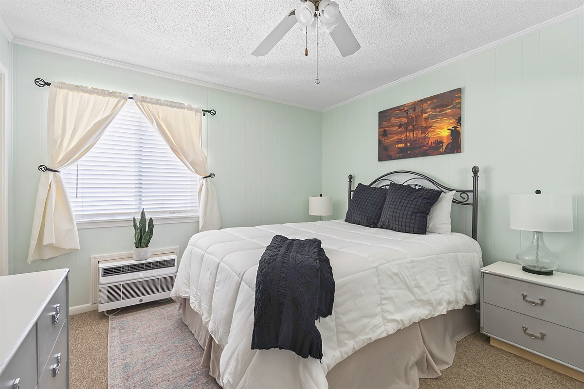 Primary Bedroom – Comfortable queen bed with bright window light