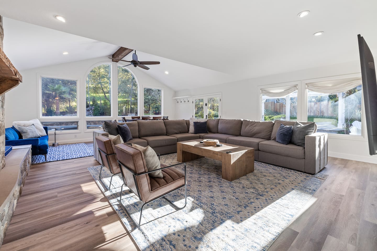 Next to the fireplace, a blue couch and window seat in the great room. The blue couch will is a Pottery Barn queen-sized sleeper sofa. A full set of queen linens are provided for guest use.
