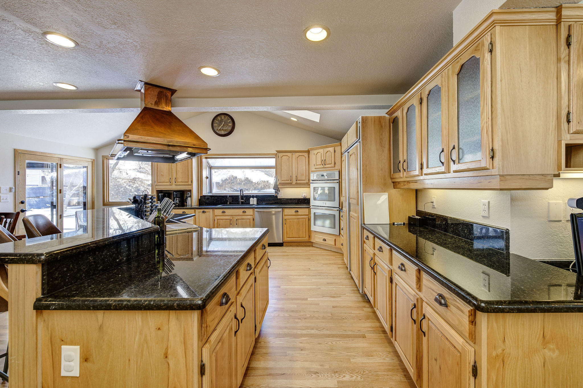 Large chef kitchen featuring double oven, Sub Zero Refrigerator and indoor grill.