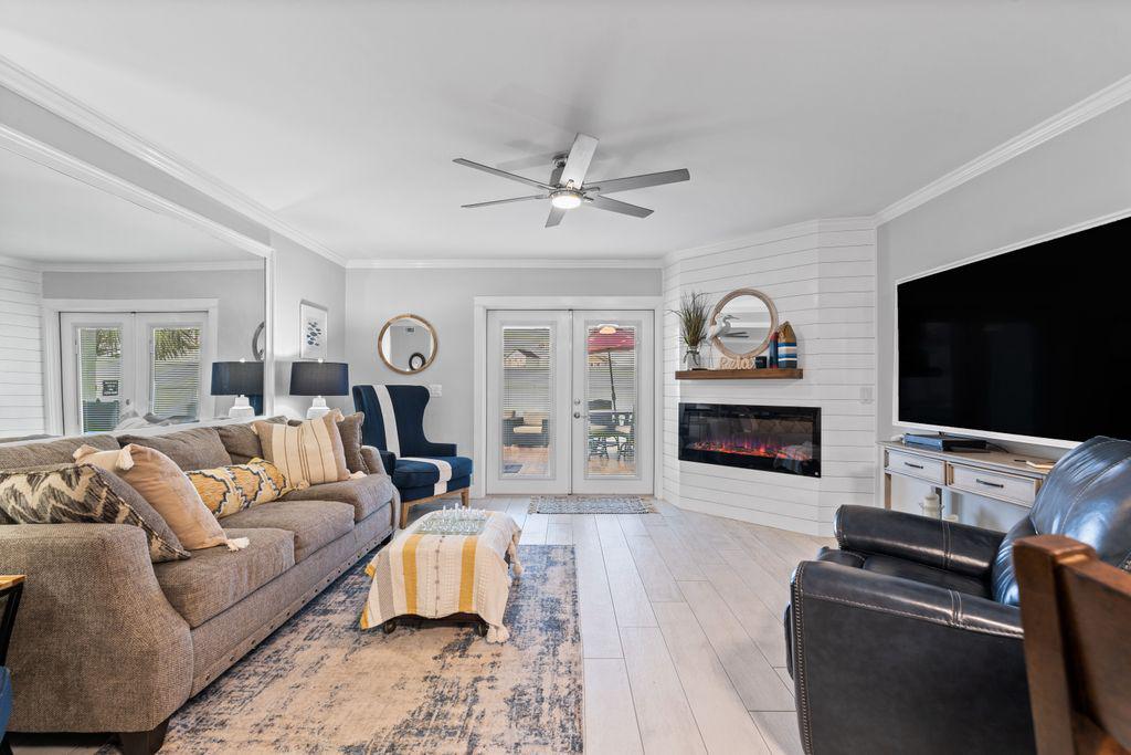 Spacious living area with recliner, fireplace, ceiling fan and smart TV