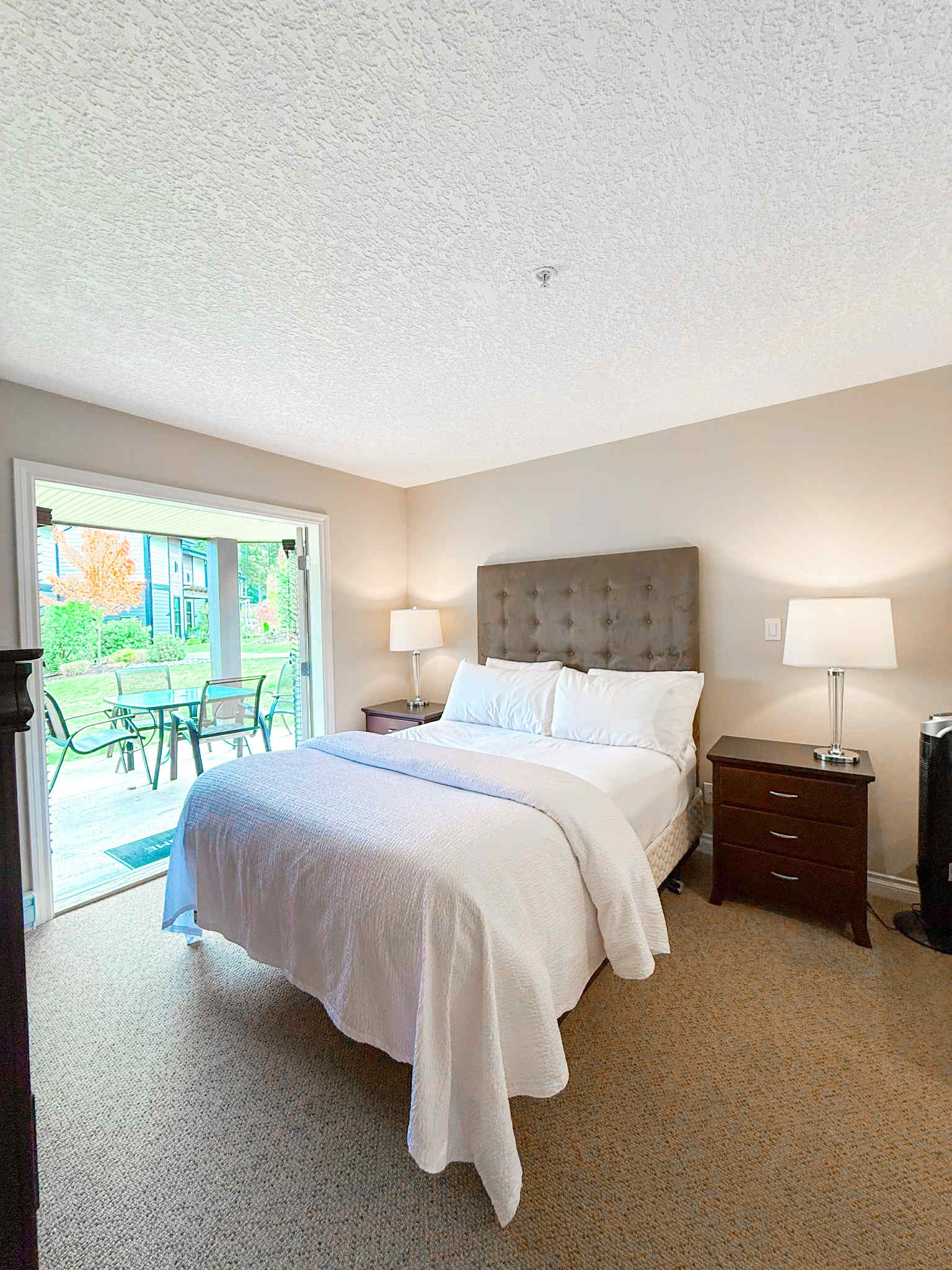 Unit A Primary Queen Bed - Double glass Patio doors.