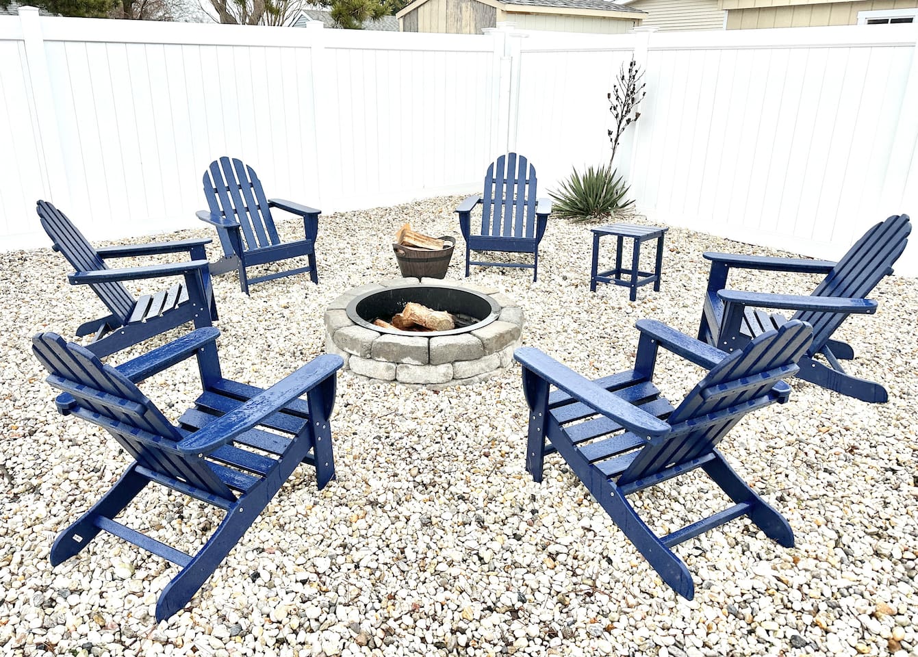 Gather around our stone fire pit for the ultimate evening under the stars. With six comfortable blue Adirondack chairs set on a tidy gravel base and enclosed by a privacy fence, it’s the perfect spot for roasting marshmallows and making memories.