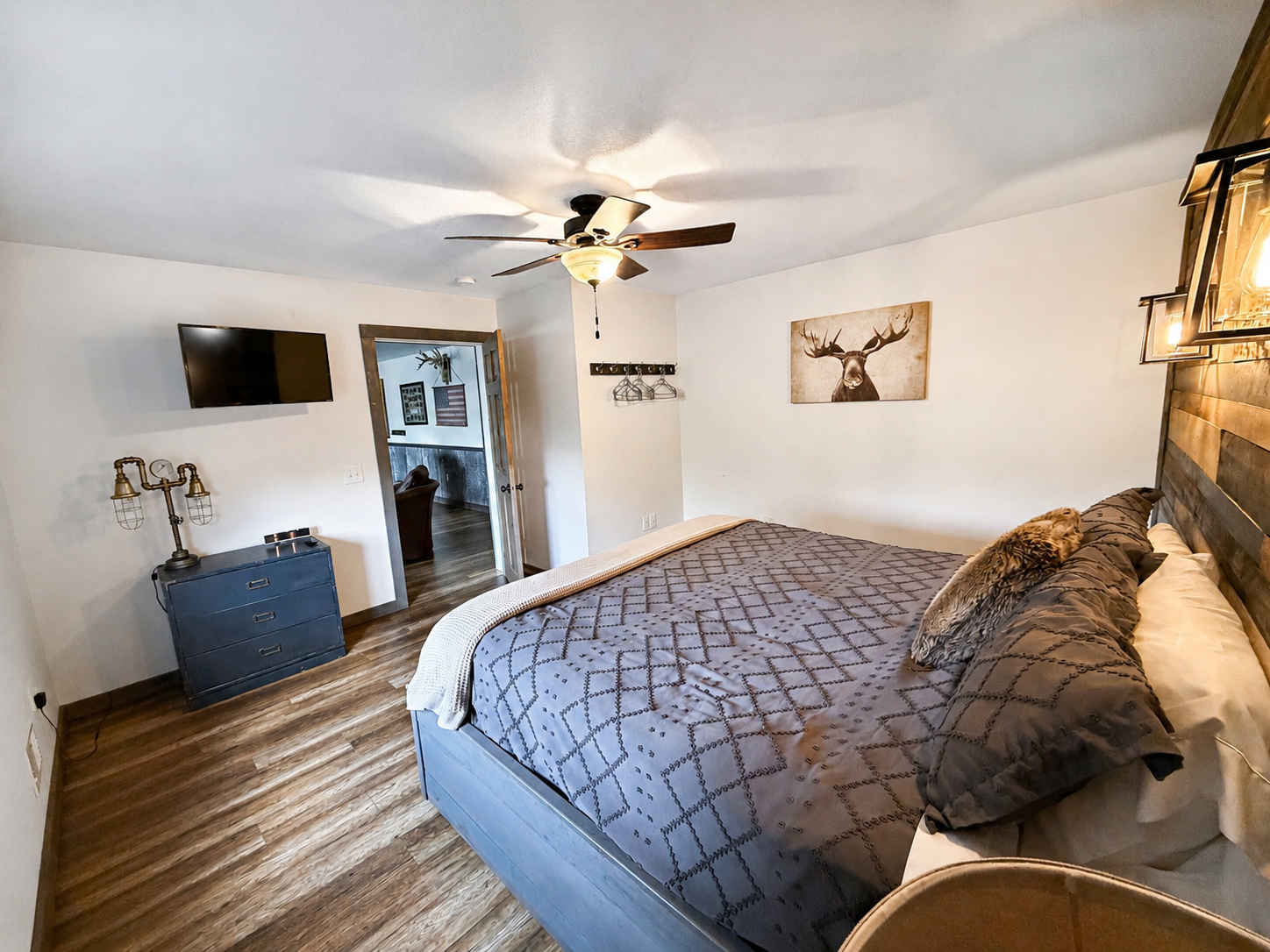 Another view of this spacious private king bed bedroom, offering comfortable sleeping accommodations, natural light, and plenty of room to settle in during your Birchwood group getaway.