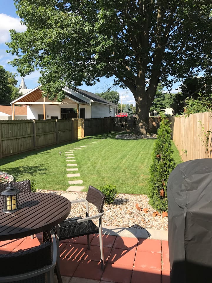 Large back yard with parking area beyond fence
