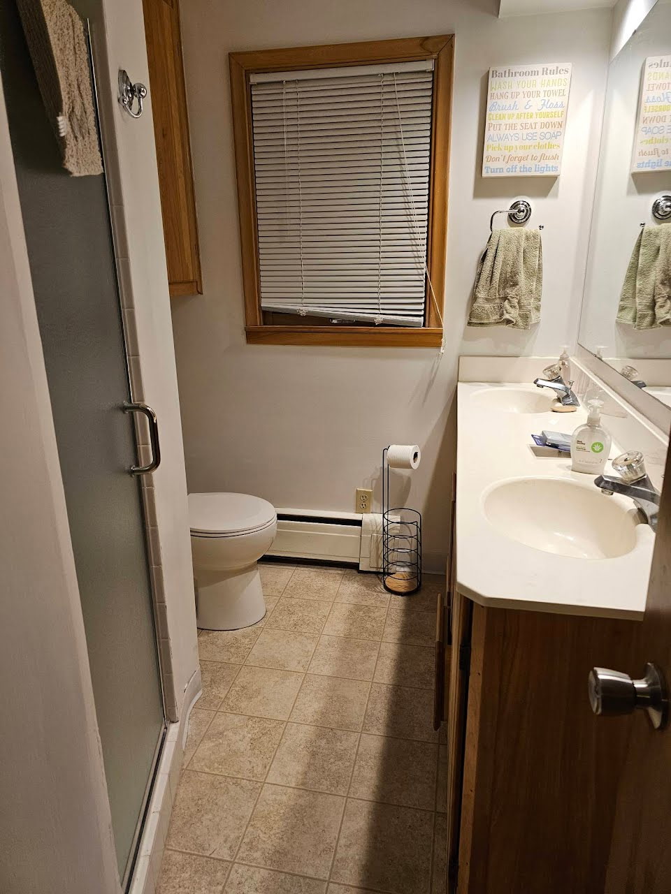 Bathroom with 2 sinks, shower, and toilet