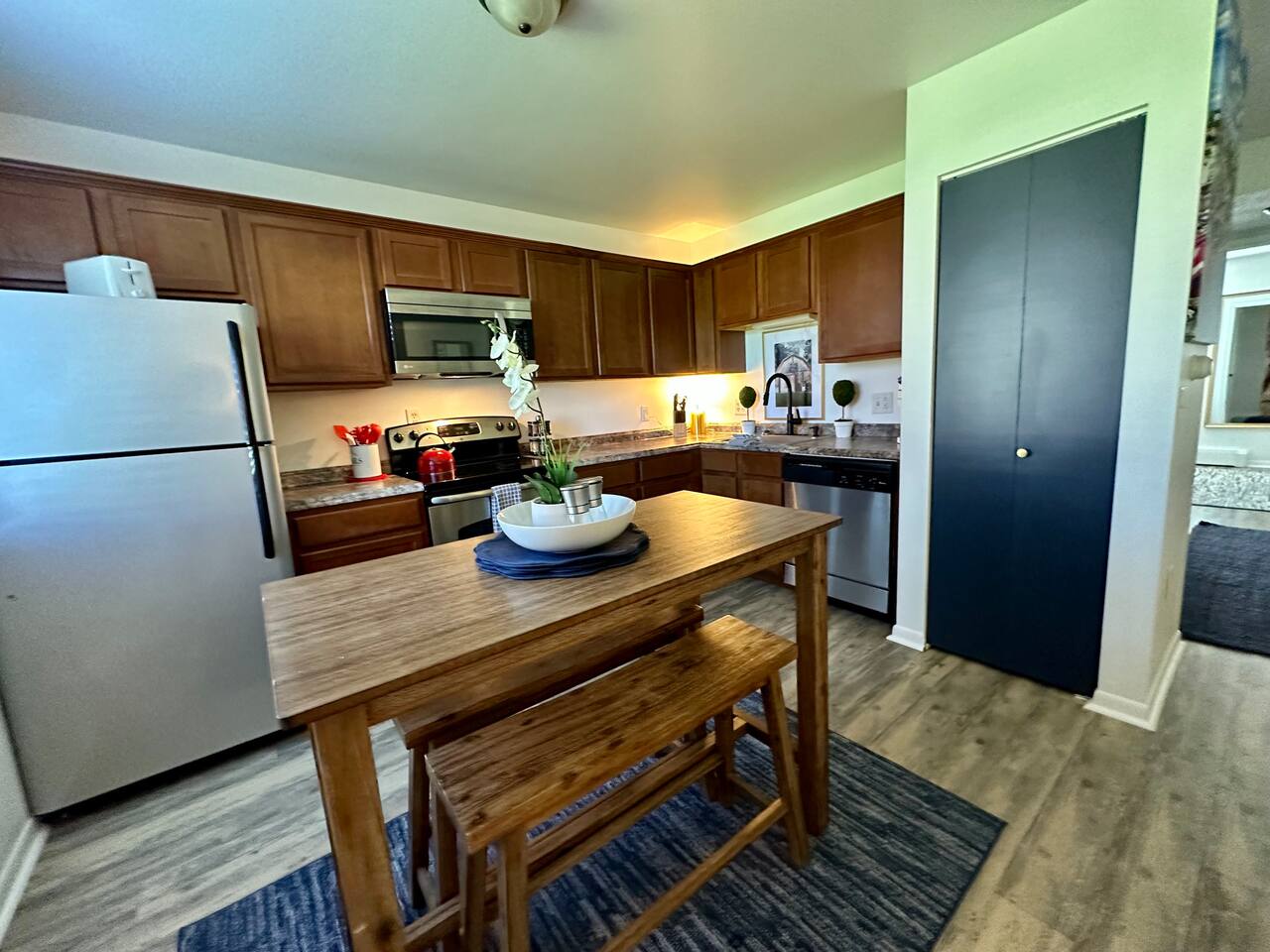 Enjoy meals or morning coffee at this  bistro table in a fully equipped kitchen featuring SSl appliances, ample counter space, and charming decor. Whether you're cooking in or dining out, this kitchen has everything you need for a great stay.
