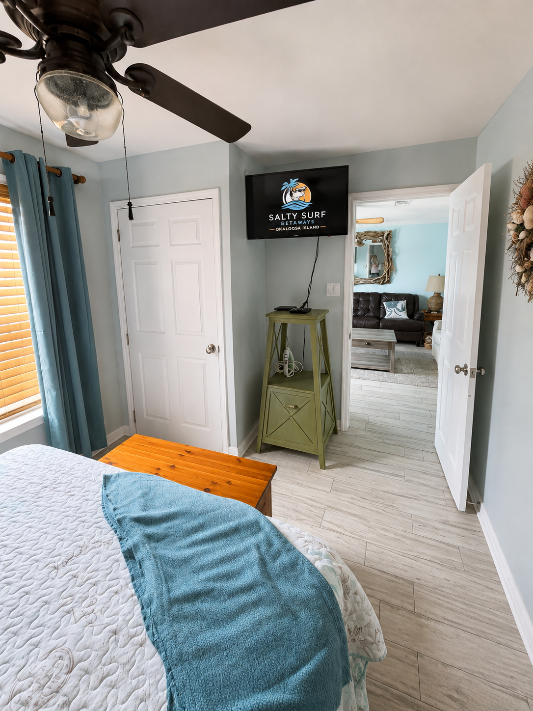 A second bedroom view highlights the TV, storage and easy flow into the living area for a comfortable stay.