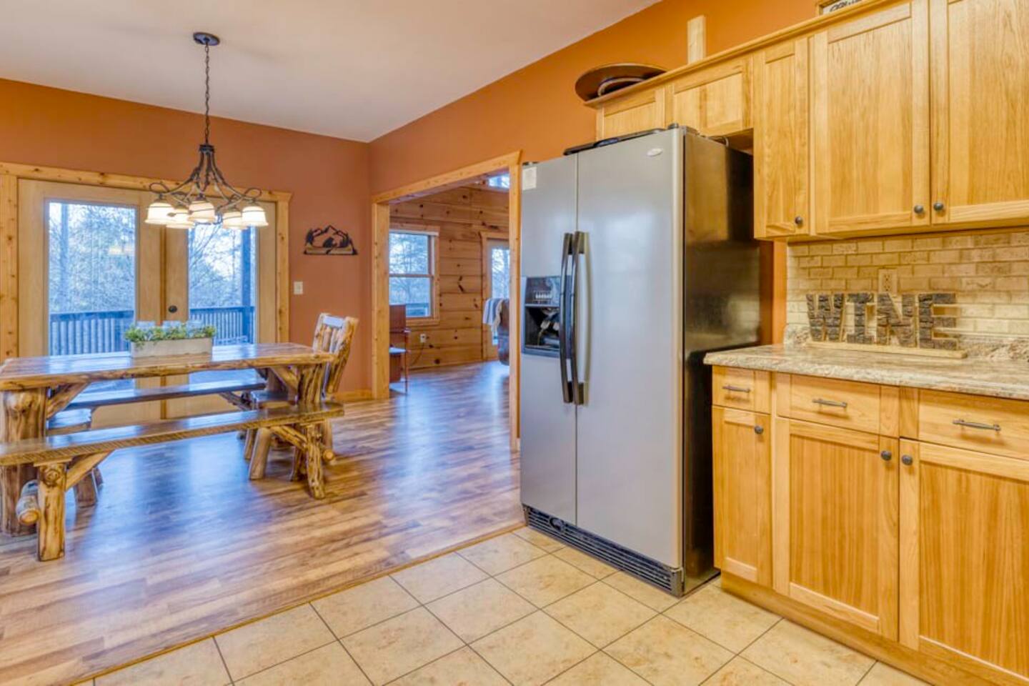 The kitchen area is equipped with a refrigerator and a dining table for your convenience.