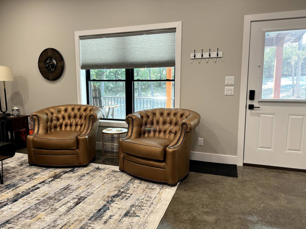 The main entrance into the living room. Sit in the leather swivel chairs facing the living room or turn and face the view outside the window.