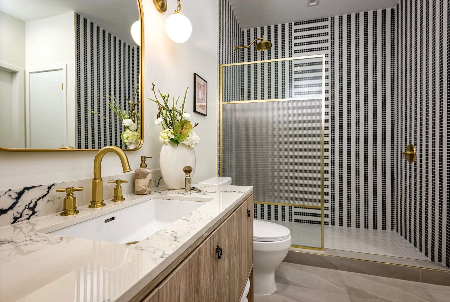 Spa-style bathroom — Calacatta marble vanity, brass fixtures & walk-in rain shower