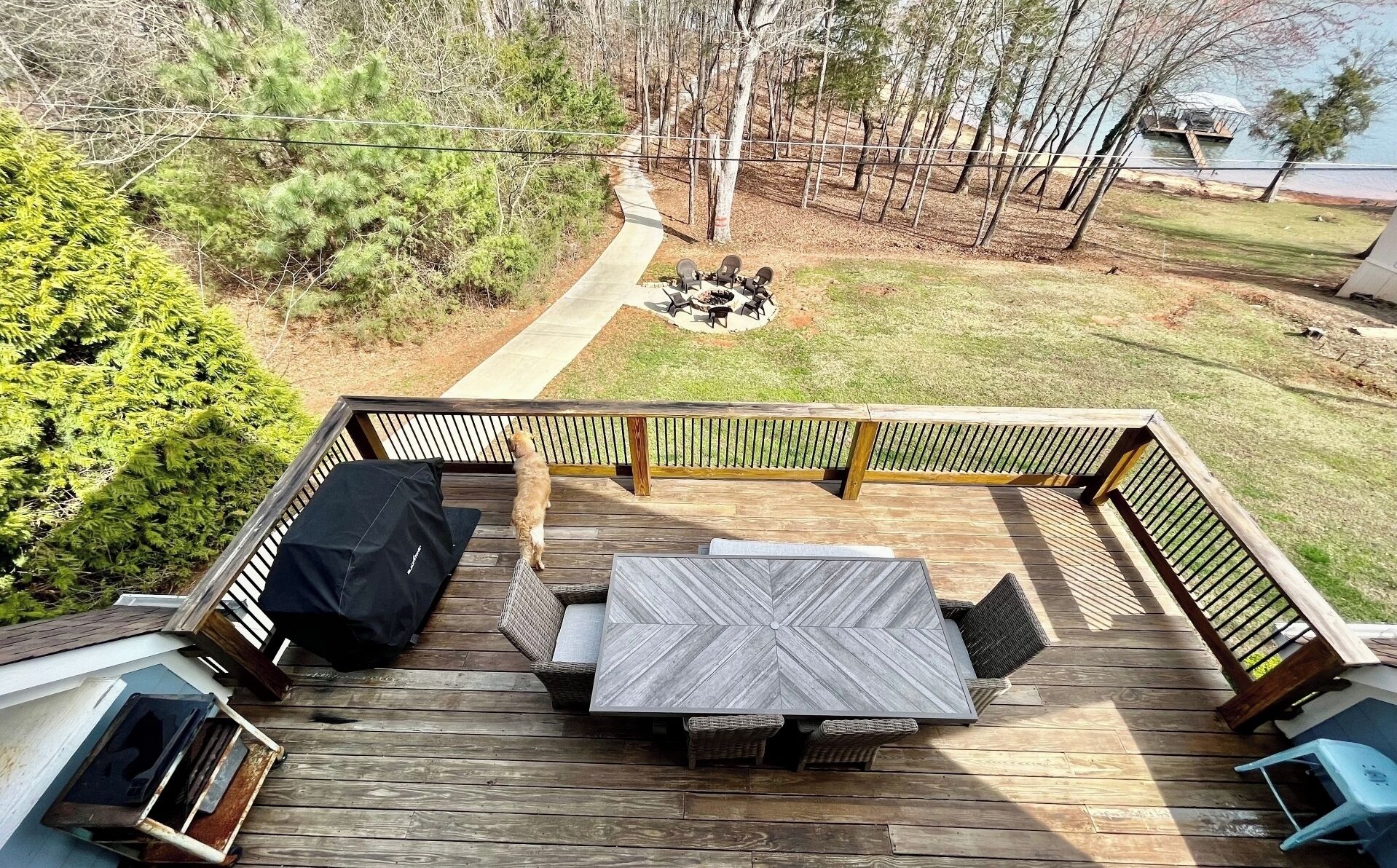 Deck with view of the water, firepit and pathway to the dock