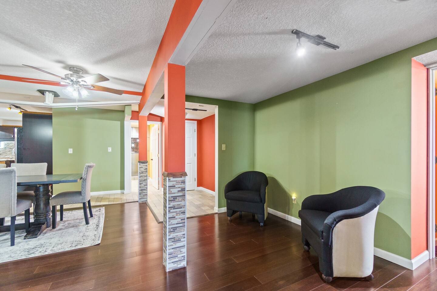 Dining area with two single couches at the back, offering a cozy and stylish space for both dining and relaxation.
