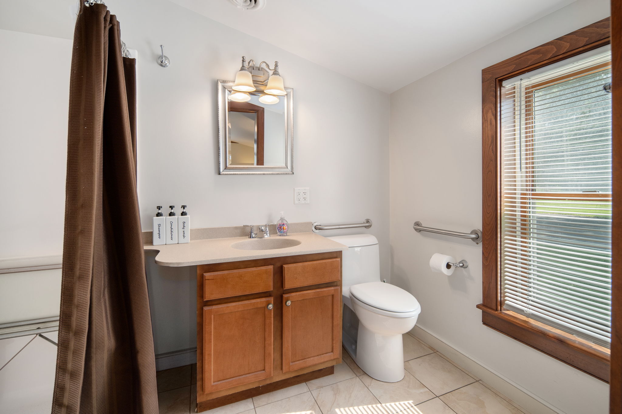Natural light brightens the bathroom's vanity and shower area.