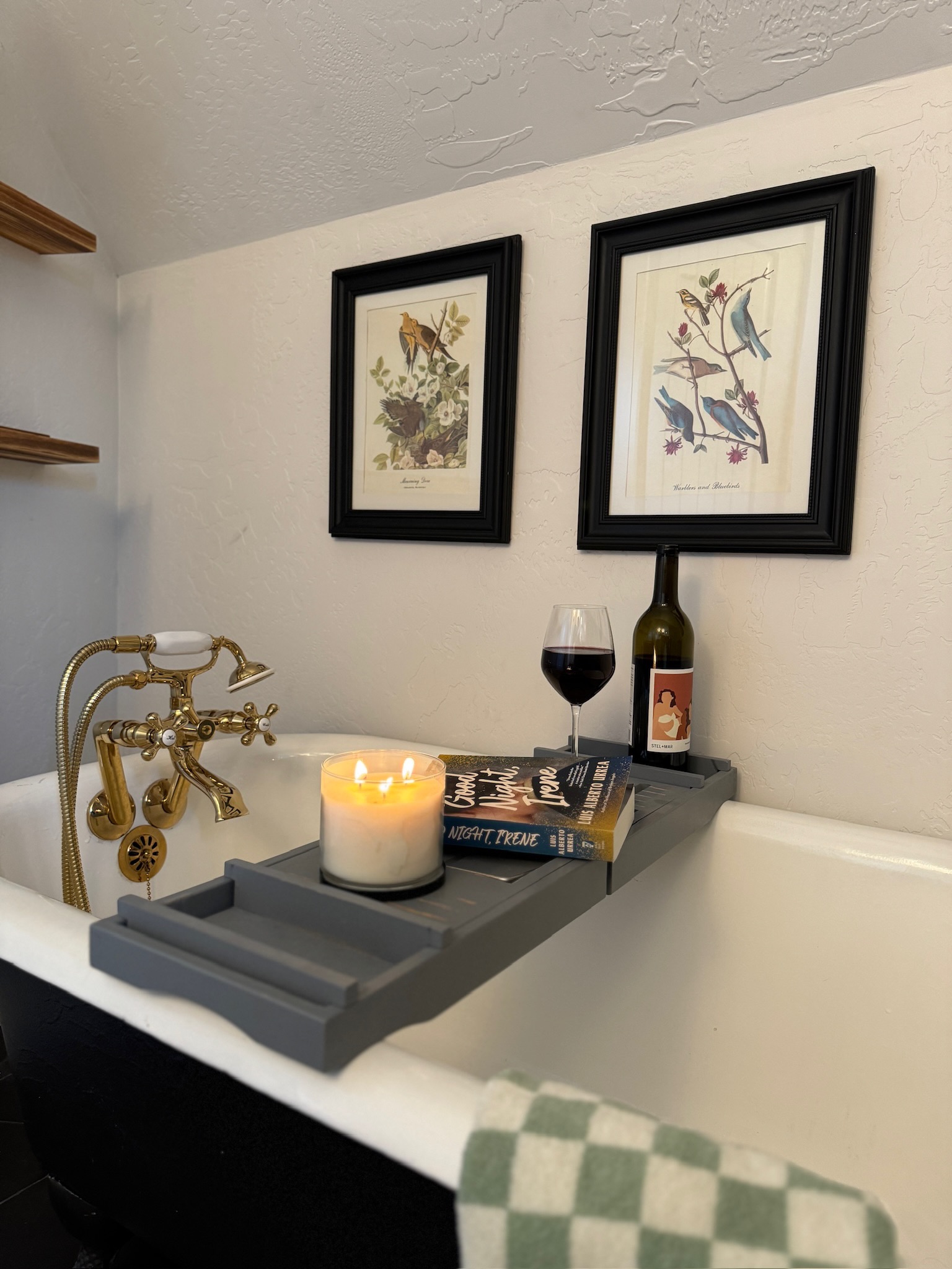 This master bathroom features a clawfoot soaking tub and shower for a relaxing bathing experience.