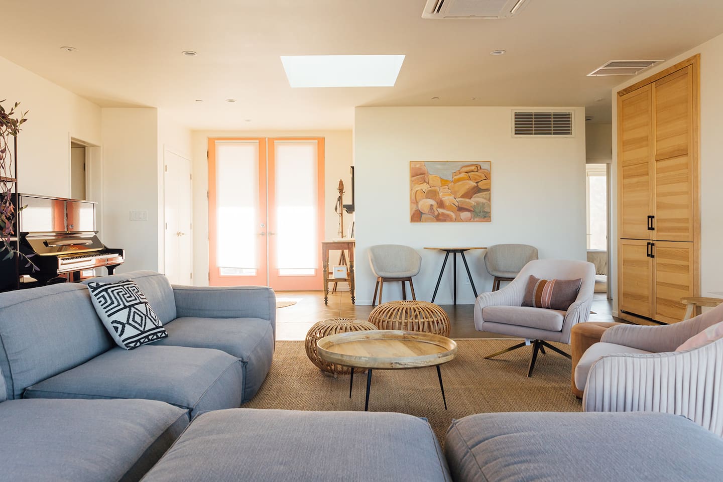Primary family room with lots of comfortable seating space and piano.