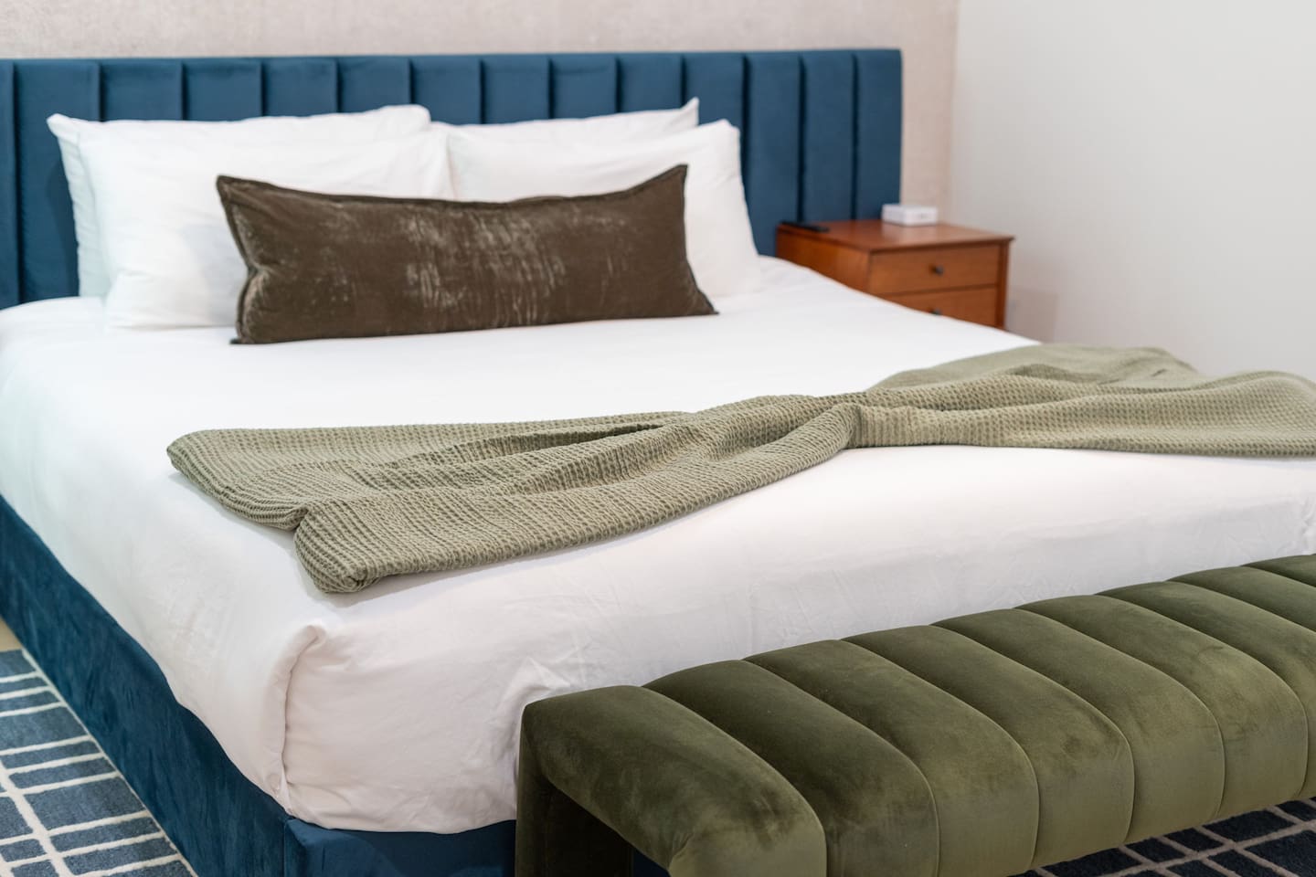 Comfortable king bed dressed in crisp linens and accent pillows.