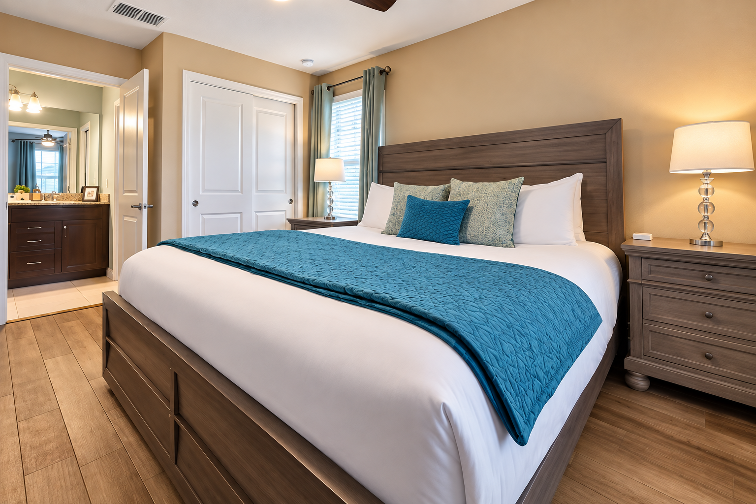 This king-size bedroom also has its full-size ensuite bathroom with double sink vanity and added space.