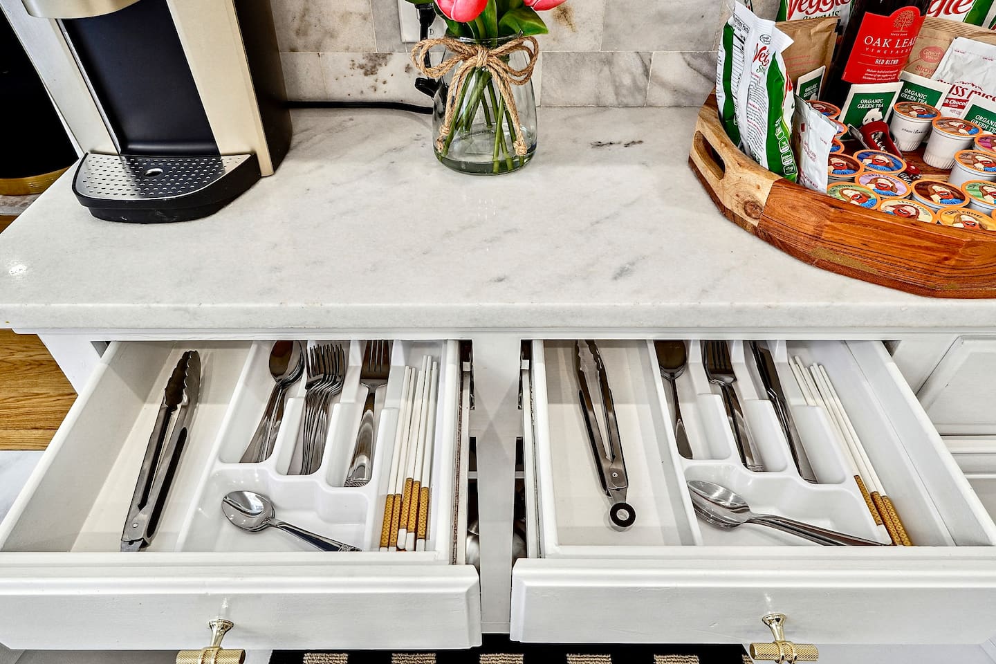 Bright and beautifully designed kitchen with white marble counters and white wood cabinetry. Fully equipped and ideal for cooking, gathering, and hosting with ease.