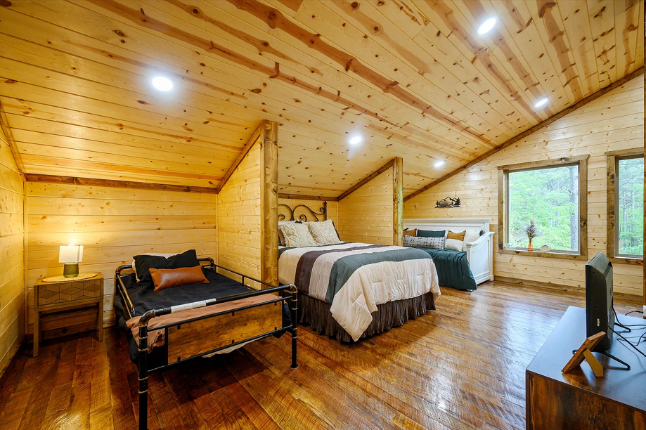 Spacious loft bedroom perfect for families, groups, and relaxing stays