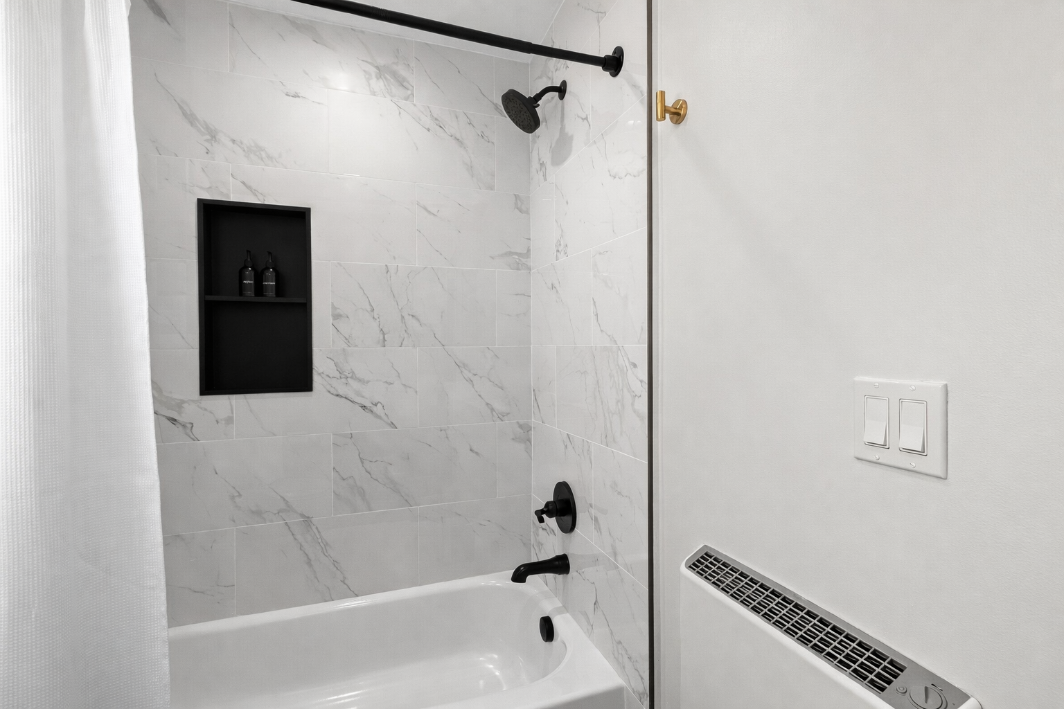 Sleek tub-shower combo with modern tile, matte black fixtures, and built-in storage—clean, stylish, and perfect for a refreshing start or relaxing soak.