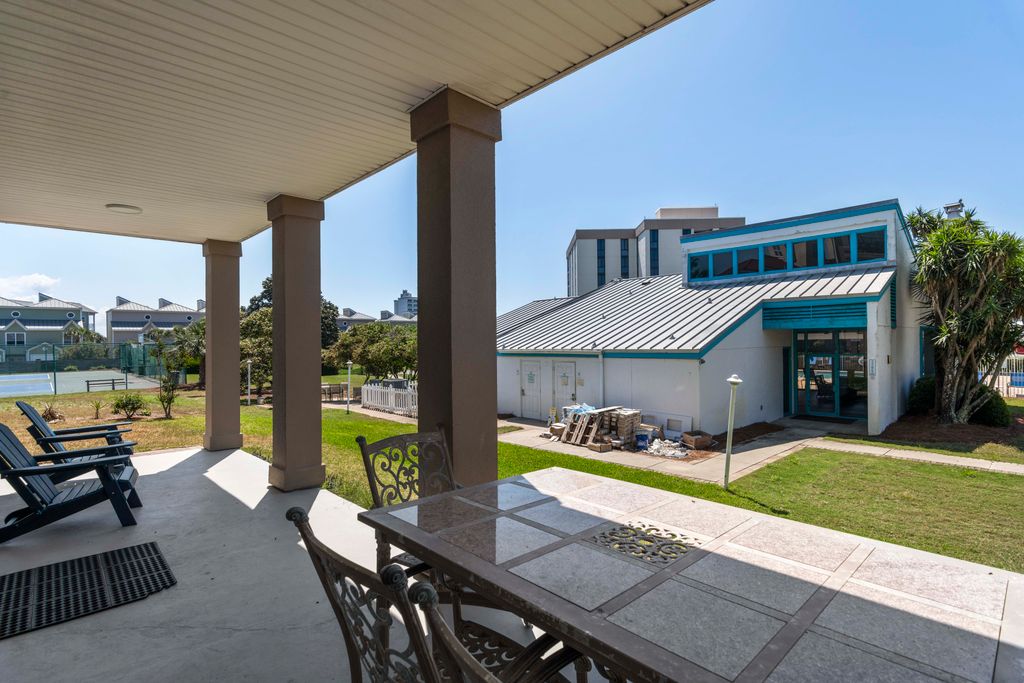 Back Patio – Spacious back porch with views of the community pool, the closest house to the pool.