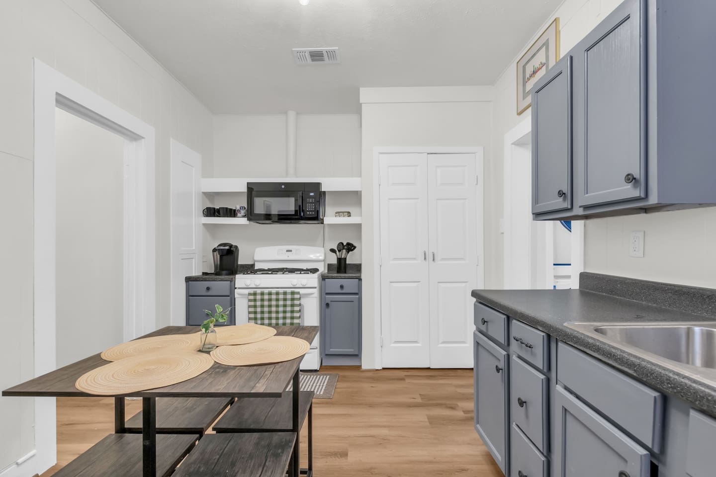 Open kitchen with island style seating and stainless steel appliances.
