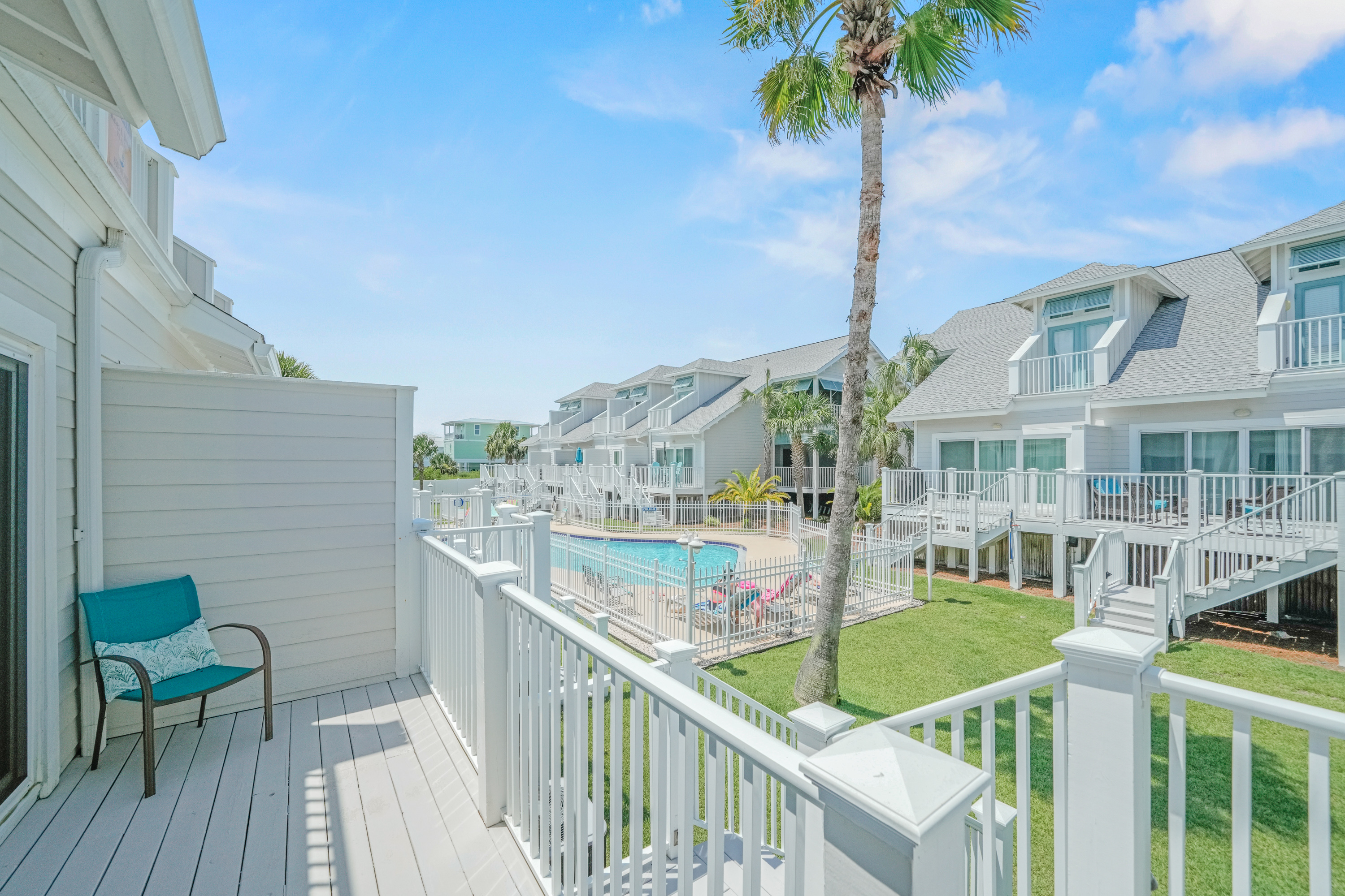 Relax on the private balcony overlooking the resort-style pool and beautifully landscaped community grounds