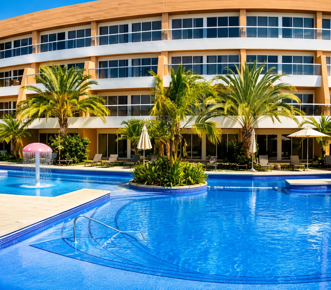 Dive into relaxation with this stunning pool surrounded by lush palms.